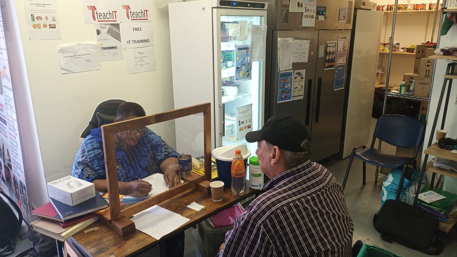 One-on-one counseling session with protective barrier