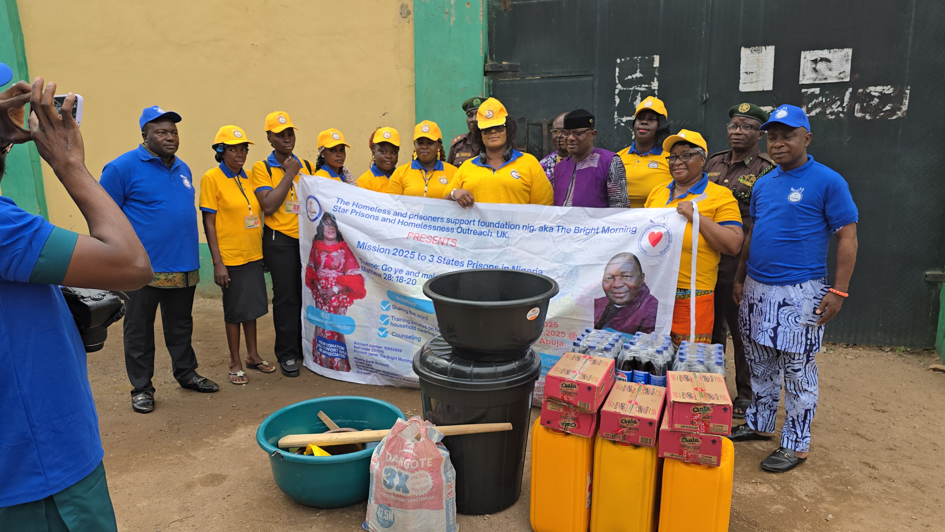 Team members with mission banner and officials