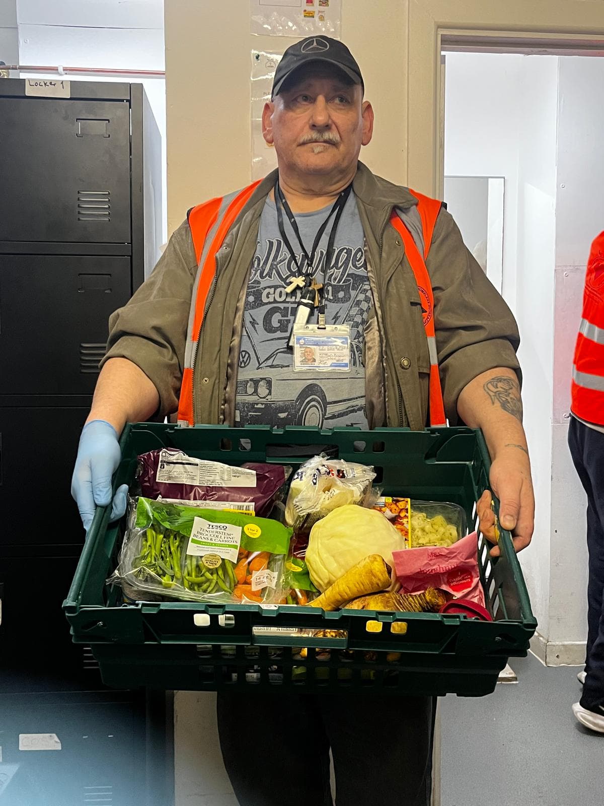 February 2026 Food Distribution - Volunteer with fresh groceries crate