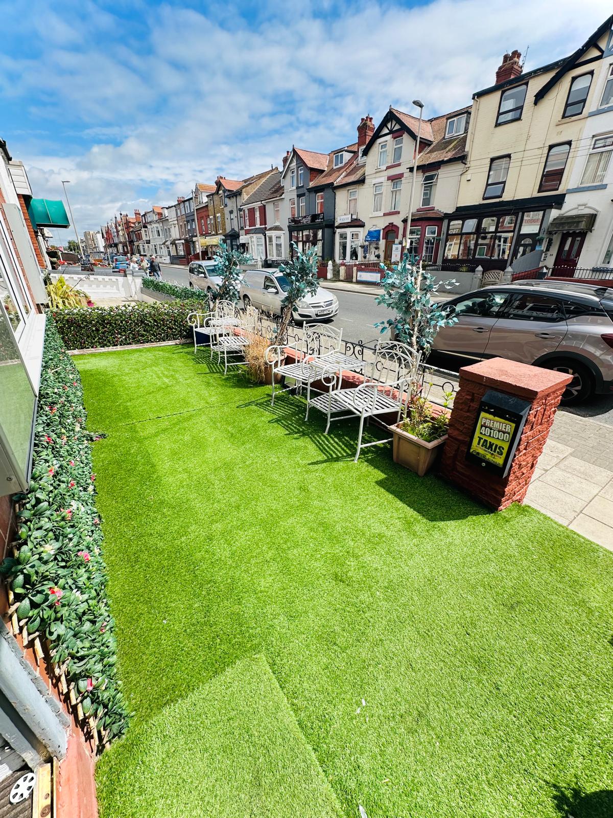 Front garden area with artificial grass and seating