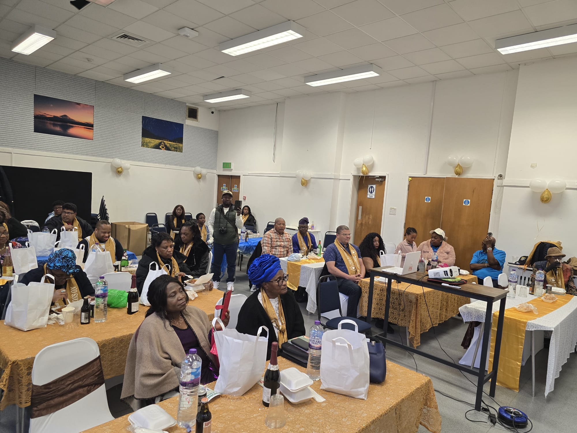 Panoramic view of the 10th anniversary celebration with community members